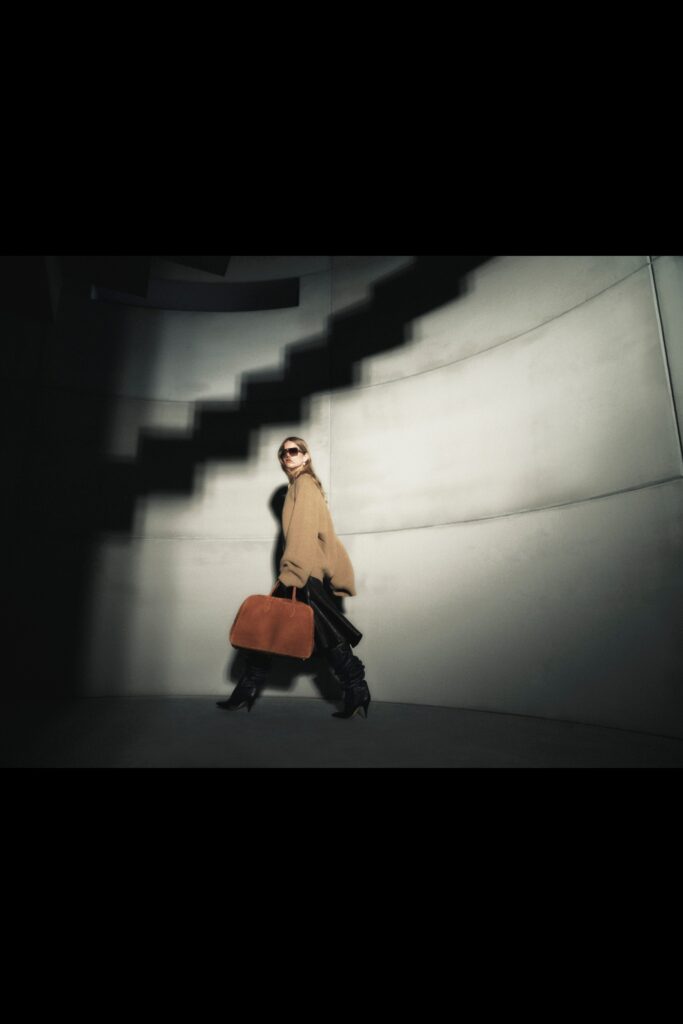 An oversized beige wool coat with long sleeves and a collared design, layered for added style.