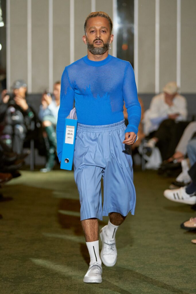 A relaxed blue long-sleeve top with an asymmetric design paired with matching pants.