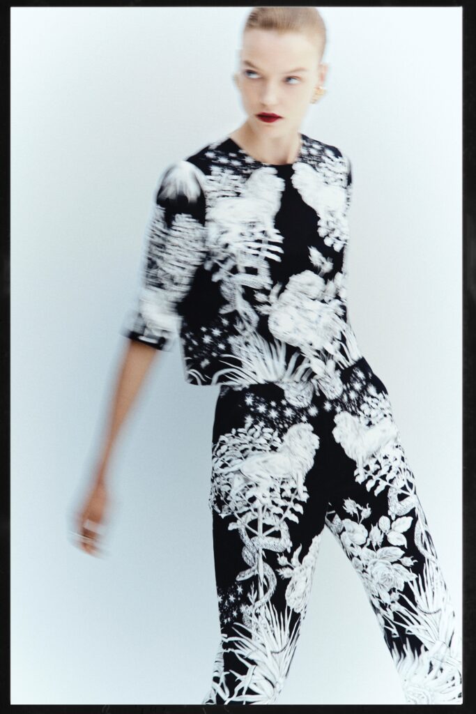 A fitted black and white printed top with short sleeves paired with matching fitted pants.
