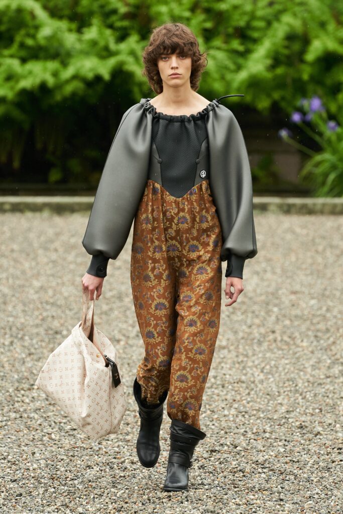 A relaxed brown printed jumpsuit with long sleeves and a collared design.