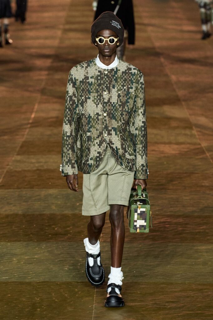 A relaxed-fit green printed jacket paired with beige shorts, perfect for a casual look.