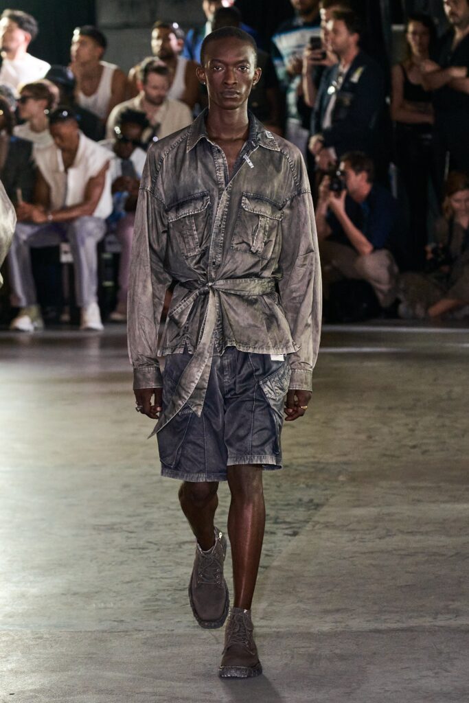 A relaxed gray cotton long-sleeve shirt paired with matching shorts featuring buttoned and zippered details.
