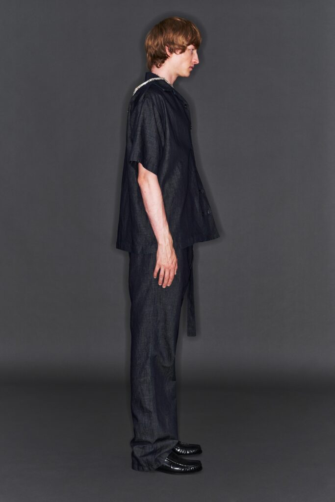 A relaxed black denim shirt with a collared neckline and straight-leg pants.
