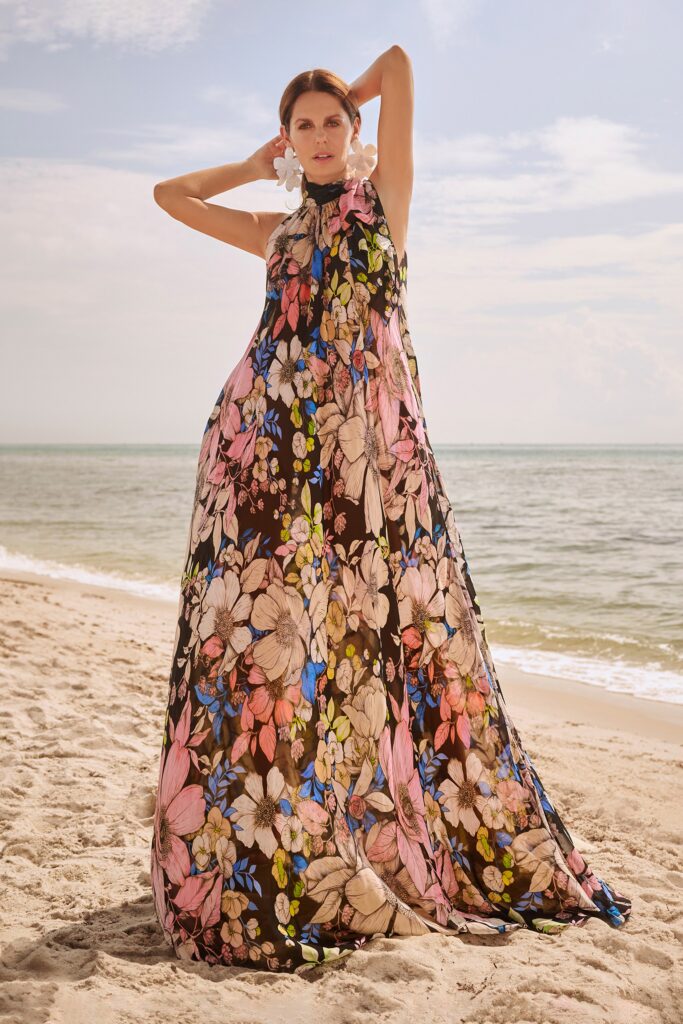 A relaxed black floral silk dress with a high neckline and flared silhouette.