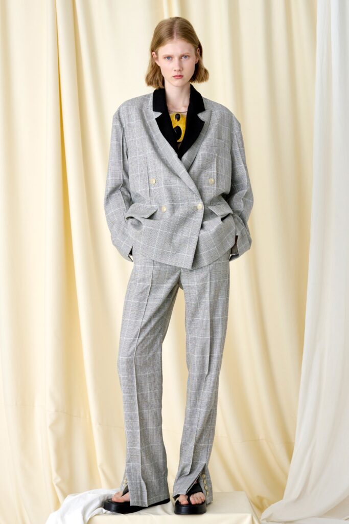 A relaxed gray checked suit with a collared long-sleeve jacket and tailored pants.