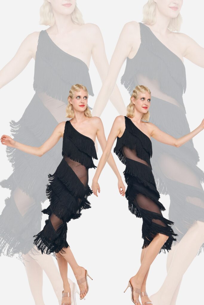 A fitted black sleeveless dress with an asymmetric design and fringed details.
