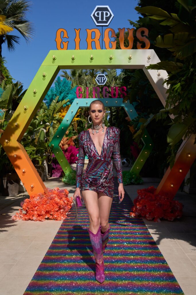 A fitted multicolor silk dress with a V-neckline and asymmetric design.