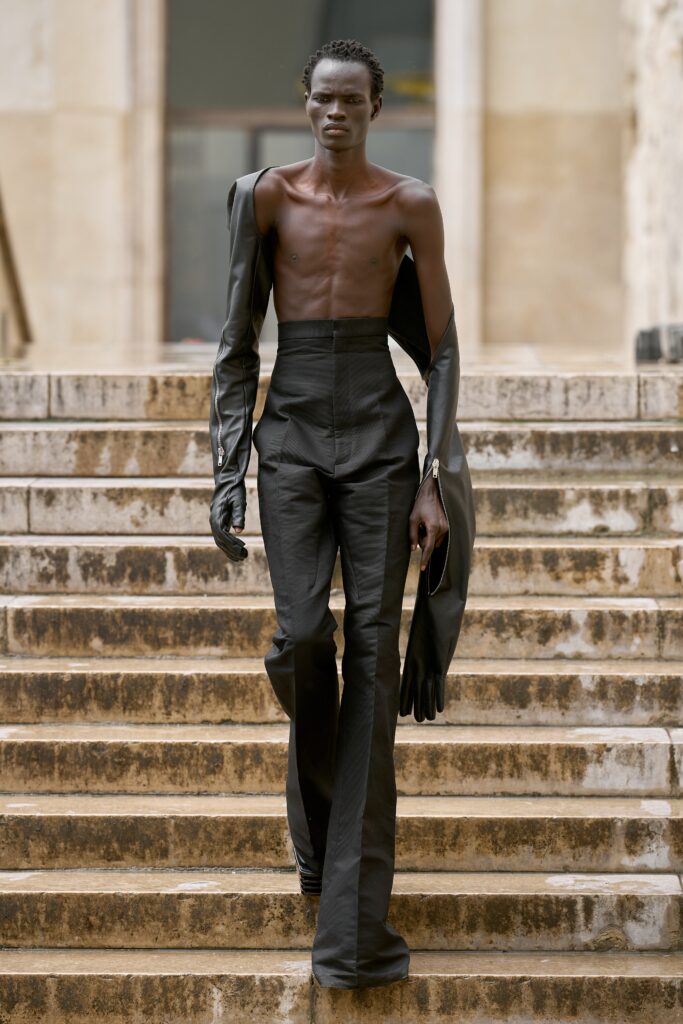 A fitted black leather ensemble featuring structured pants and a long-sleeve jacket.
