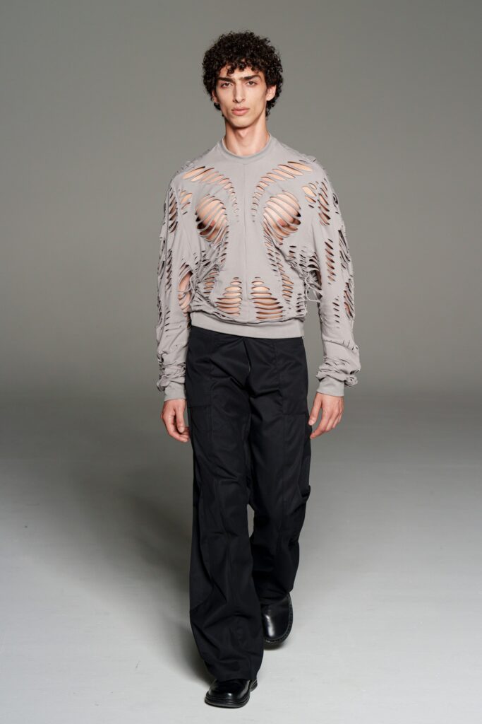 gray cutout long-sleeve top with black pants