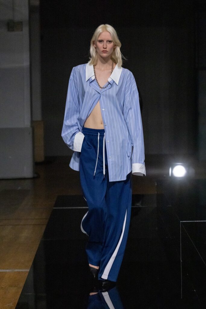 A relaxed blue striped long-sleeve shirt paired with wide-leg pants.