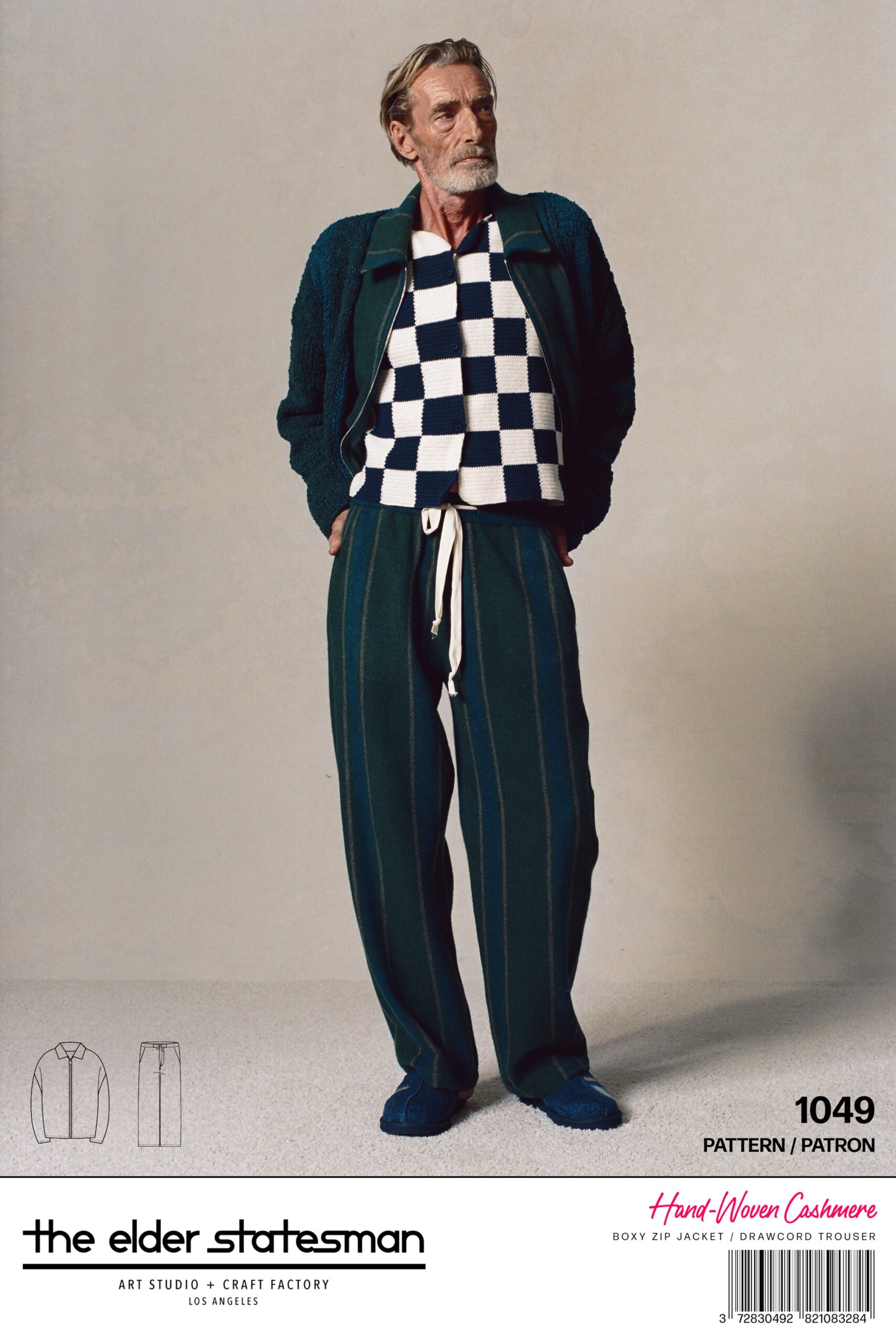 A relaxed blue and green wool jacket with long sleeves and striped trousers.