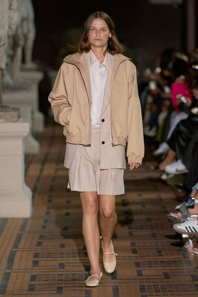 A relaxed beige cotton jacket with a collared shirt and a matching skirt.