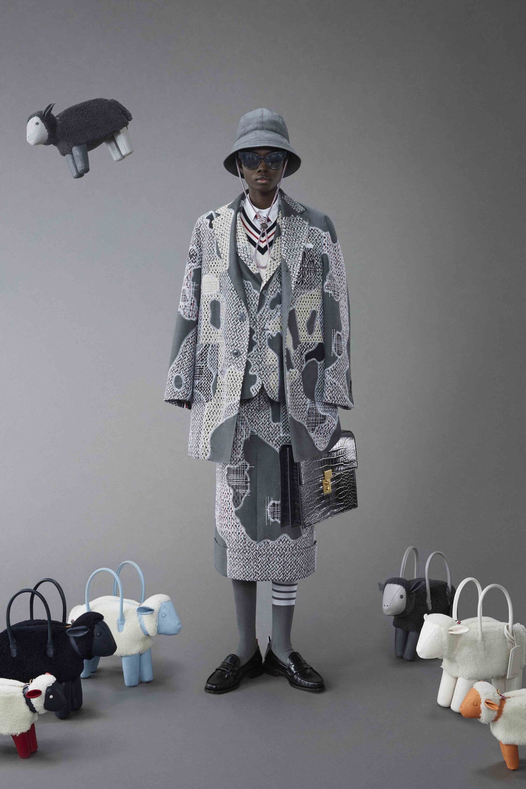 A relaxed gray printed coat with a collared neckline and a layered skirt.