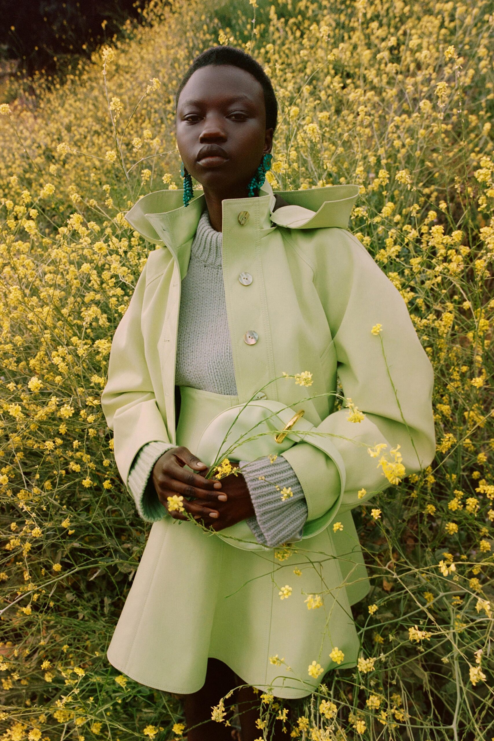 green leather coat with gray sweater