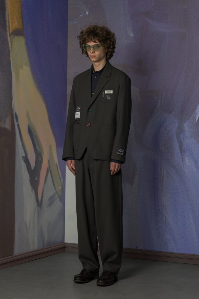 A relaxed gray cotton suit with long sleeves and a collared shirt, featuring button details.