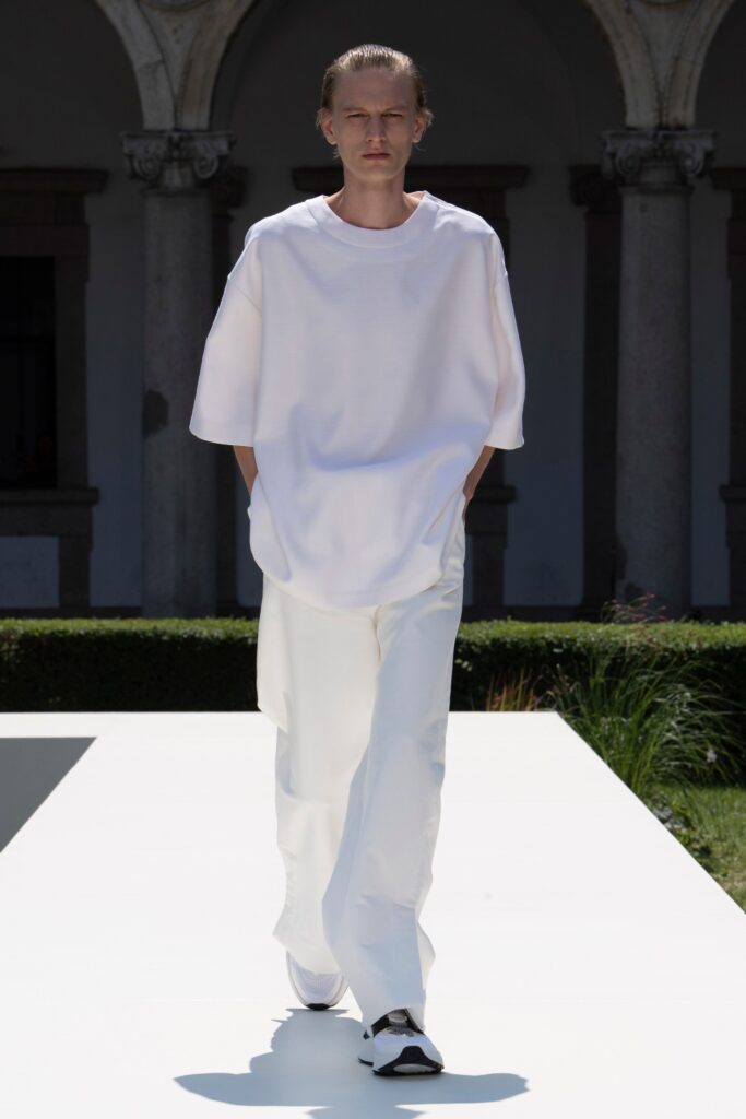 A relaxed white shirt with short sleeves paired with straight-leg pants.