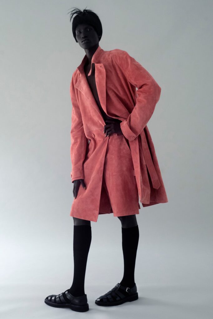 A relaxed pink suede coat paired with matching shorts, featuring a collared design and buttoned details.