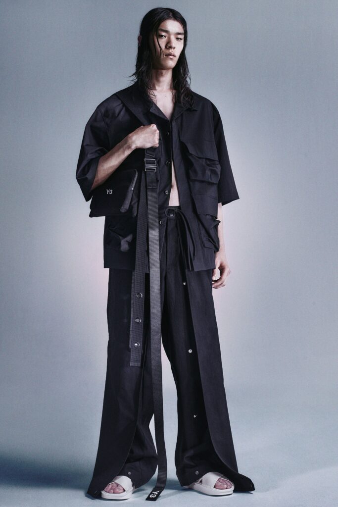 A relaxed black cotton jacket with short sleeves and wide-leg pants, featuring buttoned details.