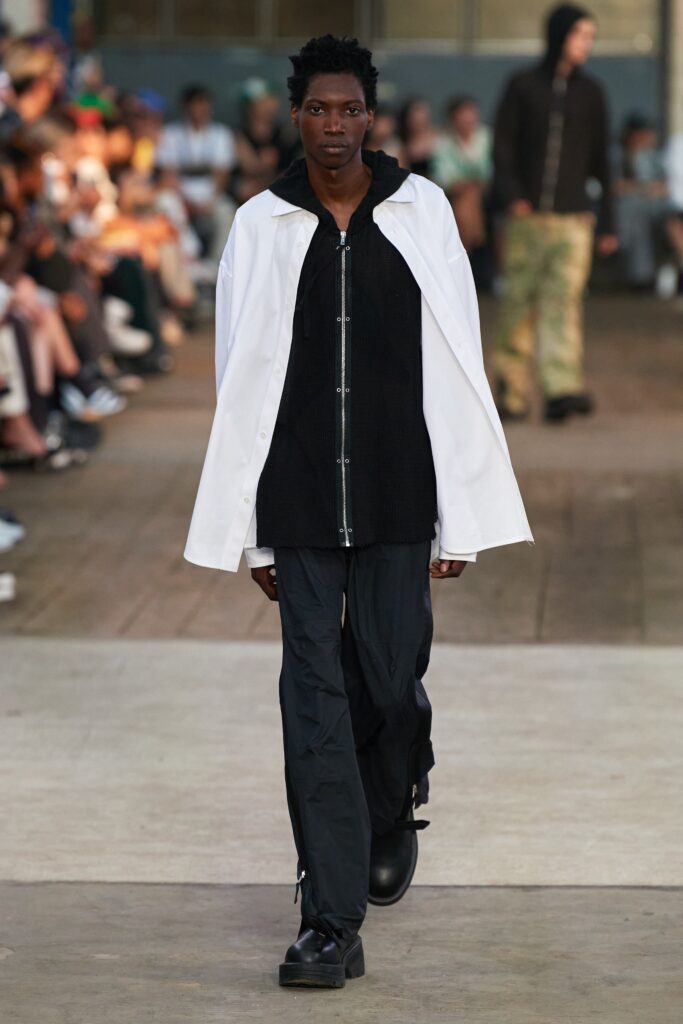 A relaxed black and white jacket with long sleeves and matching pants featuring a zippered detail.