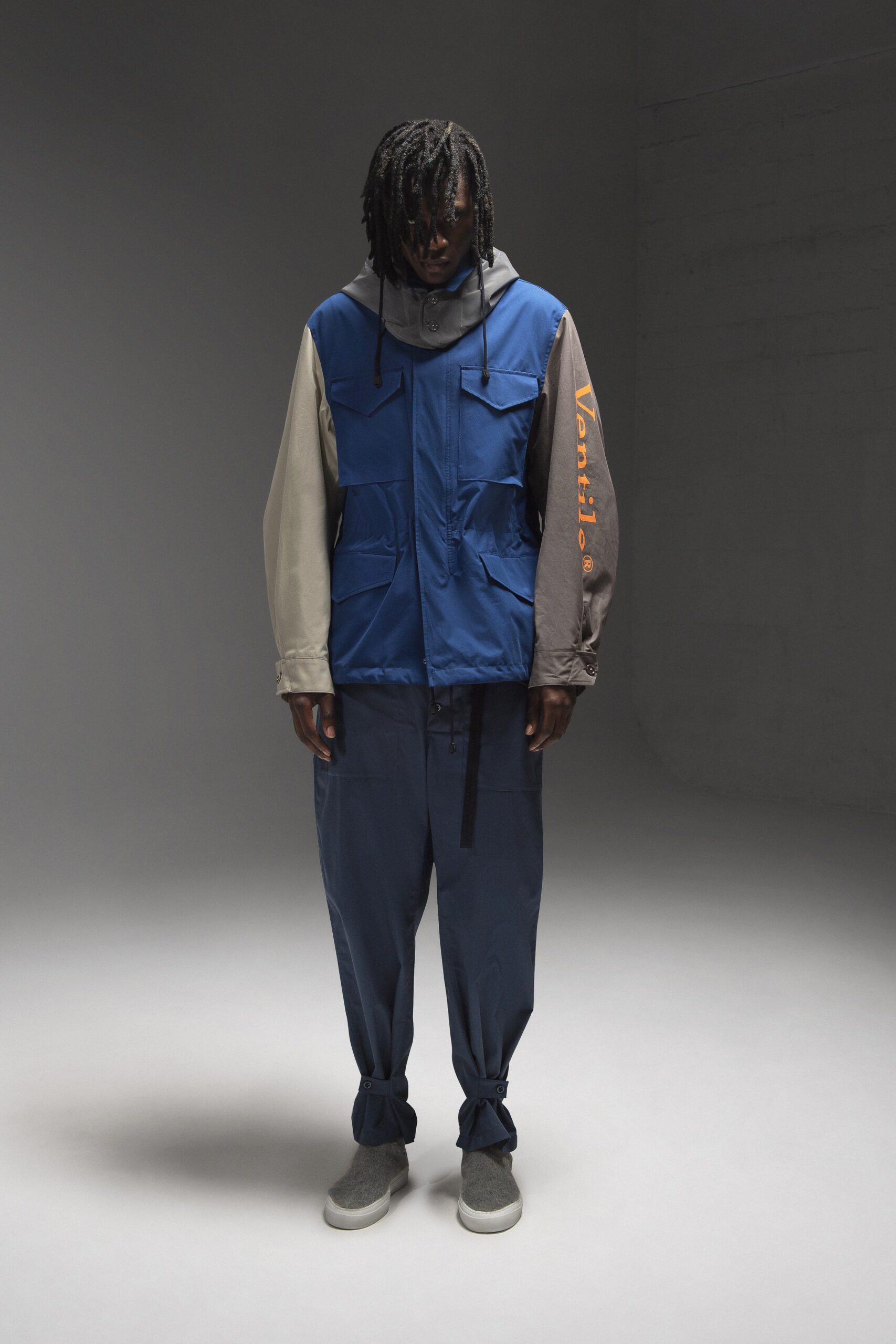A relaxed blue jacket with long sleeves paired with matching pants, featuring a layered design.