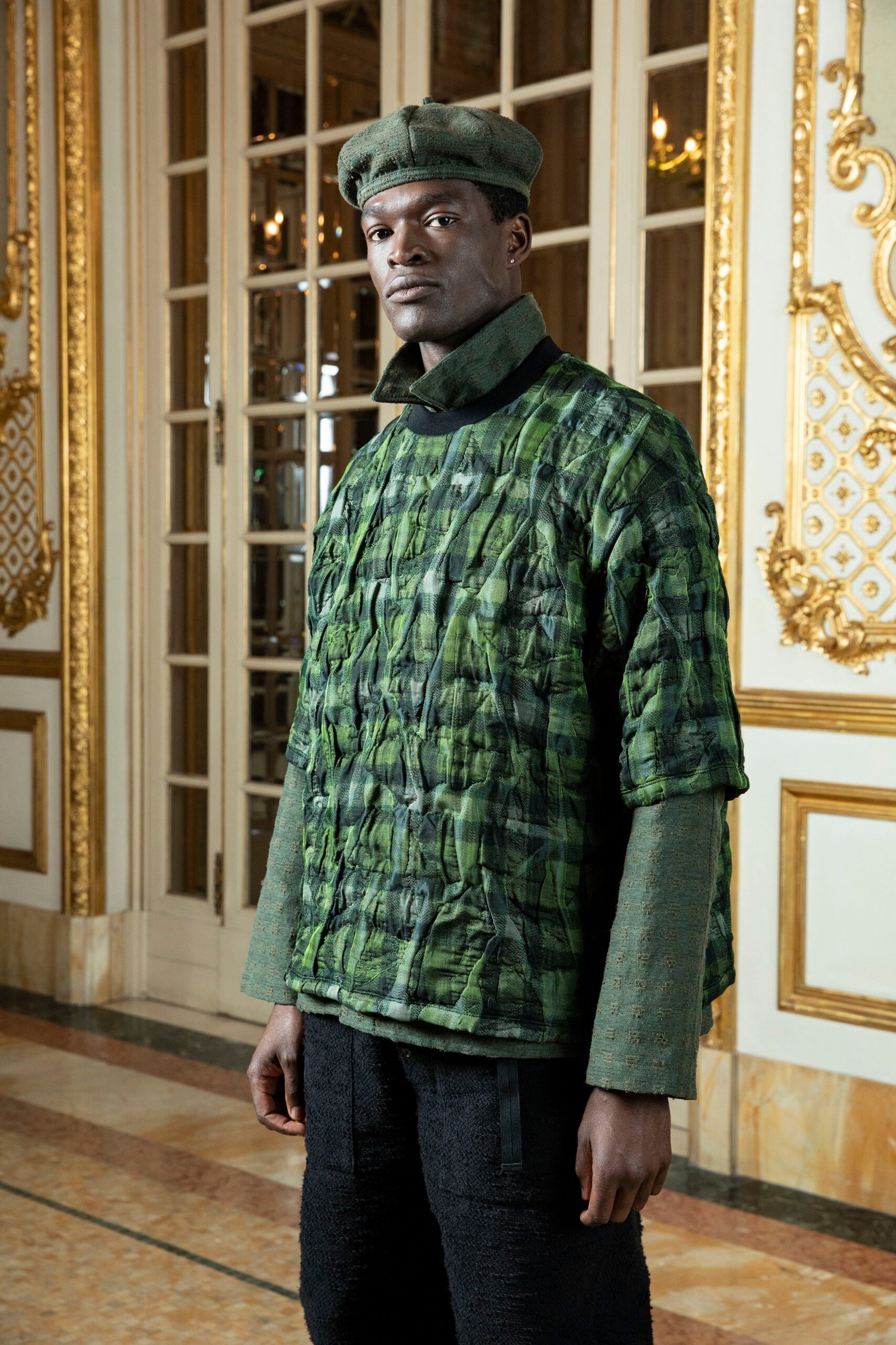 A relaxed green checked top paired with black pants, featuring long sleeves.