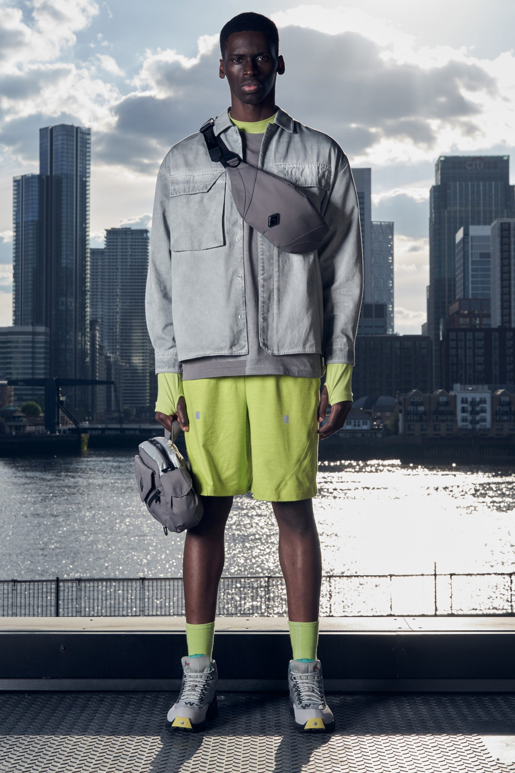 A relaxed gray jacket with long sleeves and a collared design paired with yellow shorts.