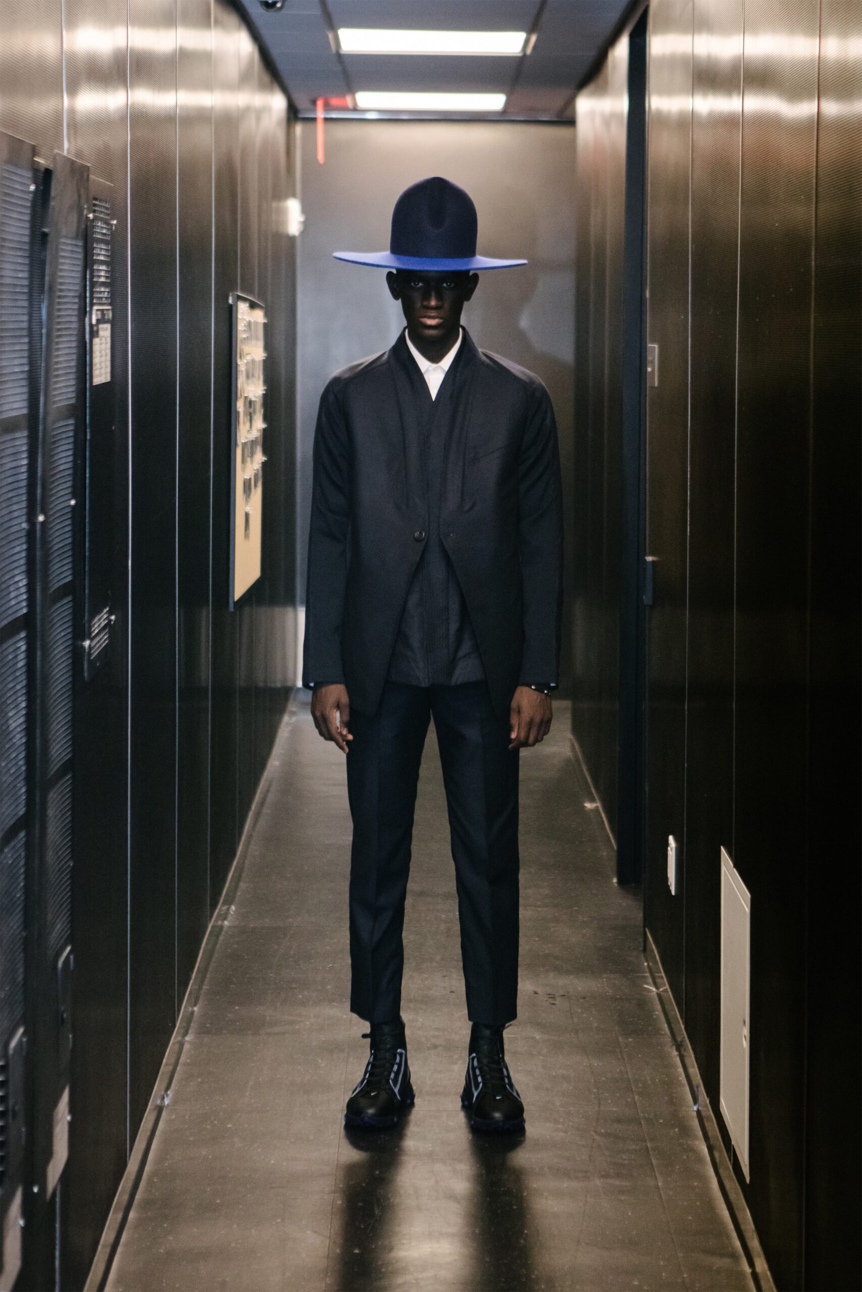 black tailored suit with blue hat