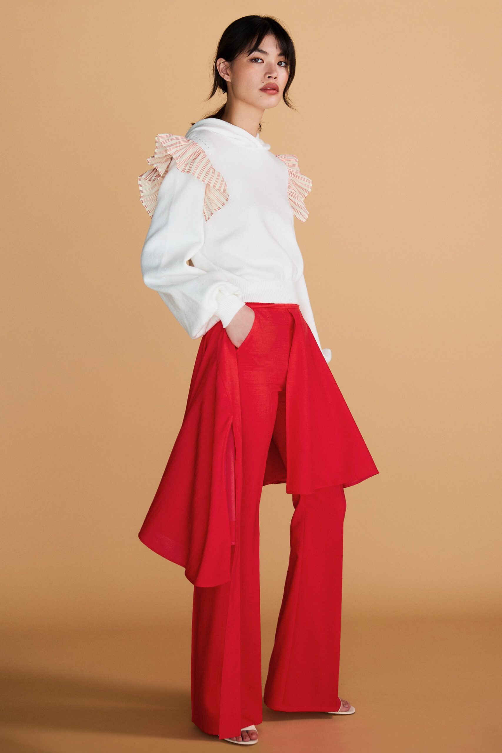 white ruffled top with red pants