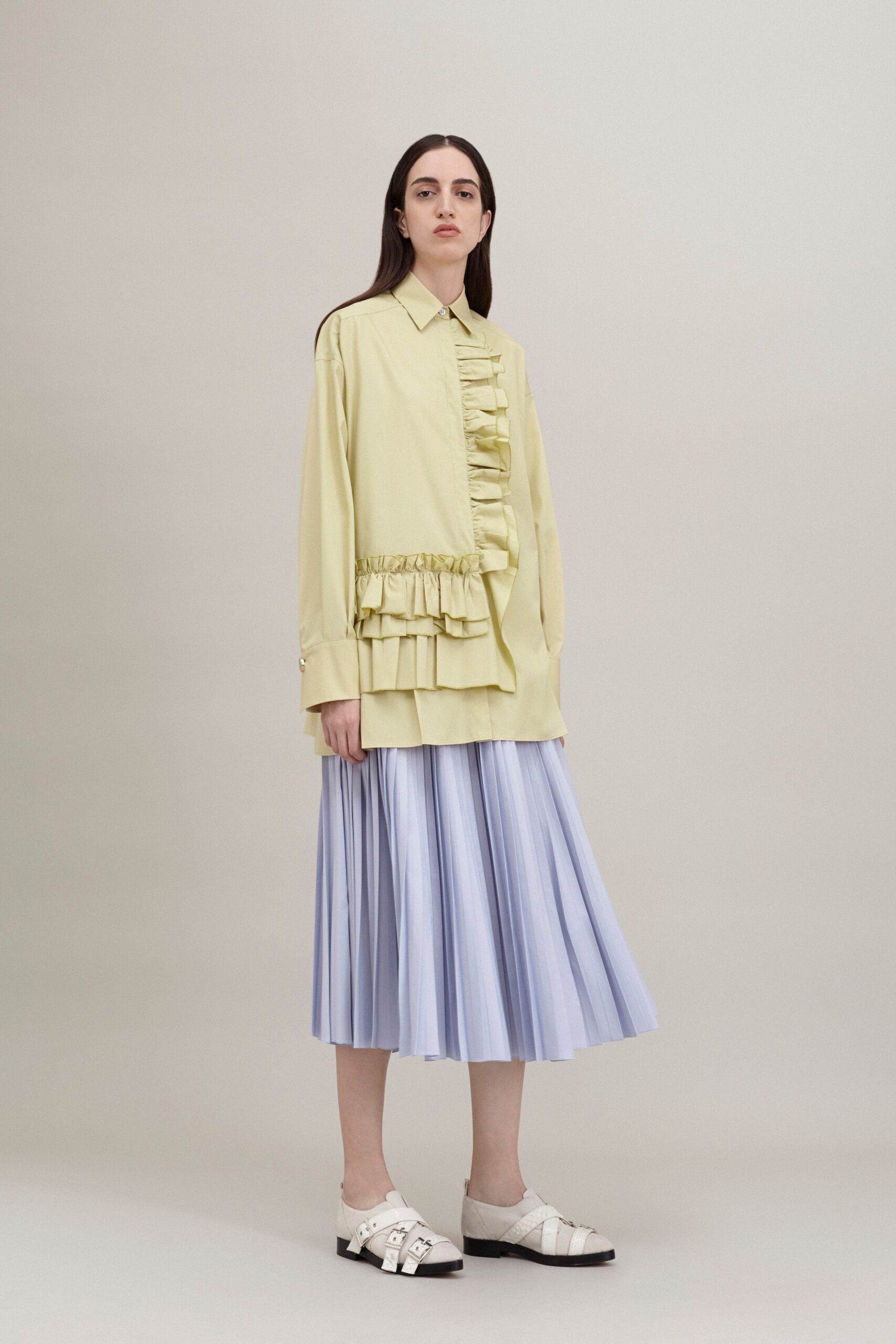 yellow shirt blue pleated skirt