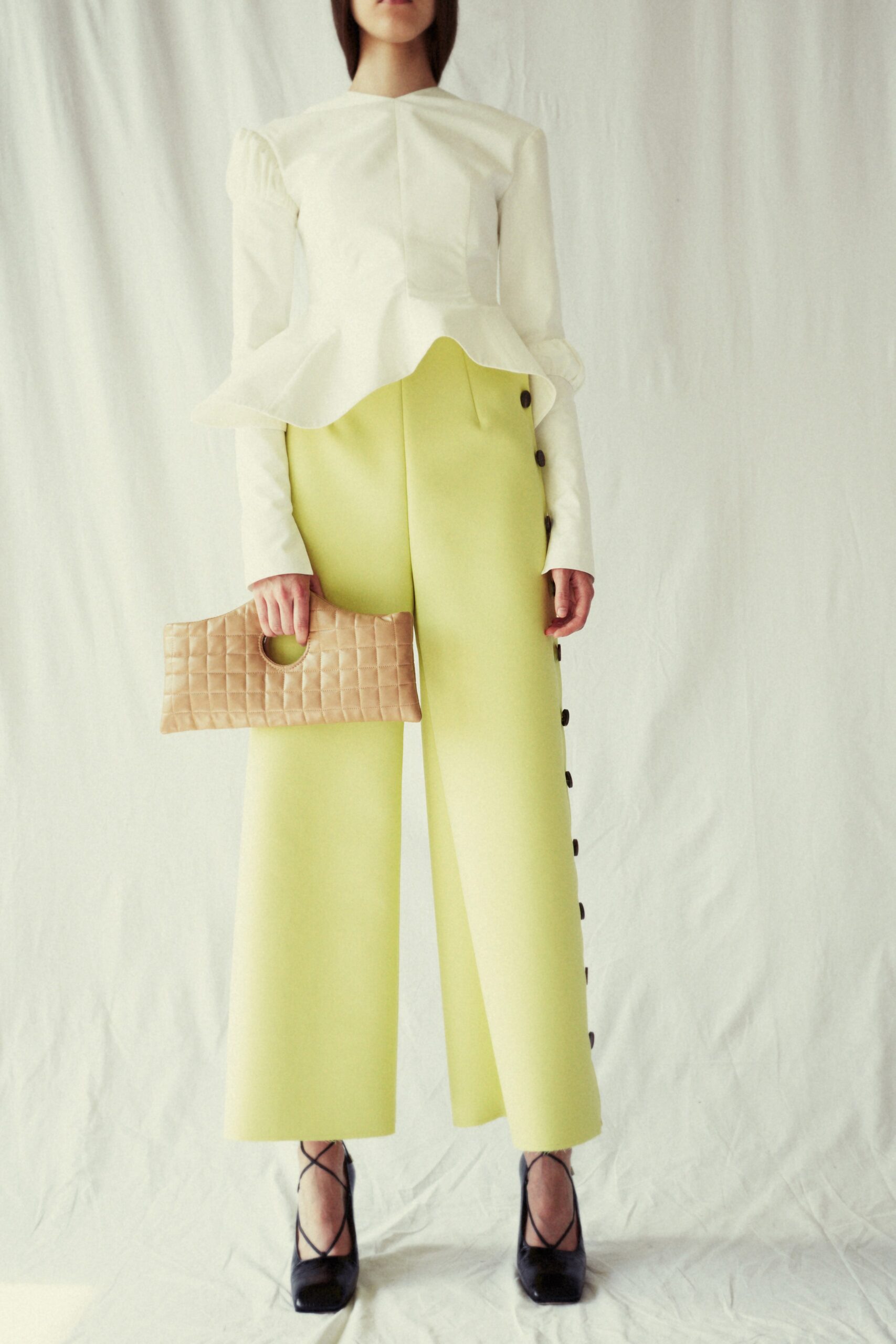white fitted top with yellow pants