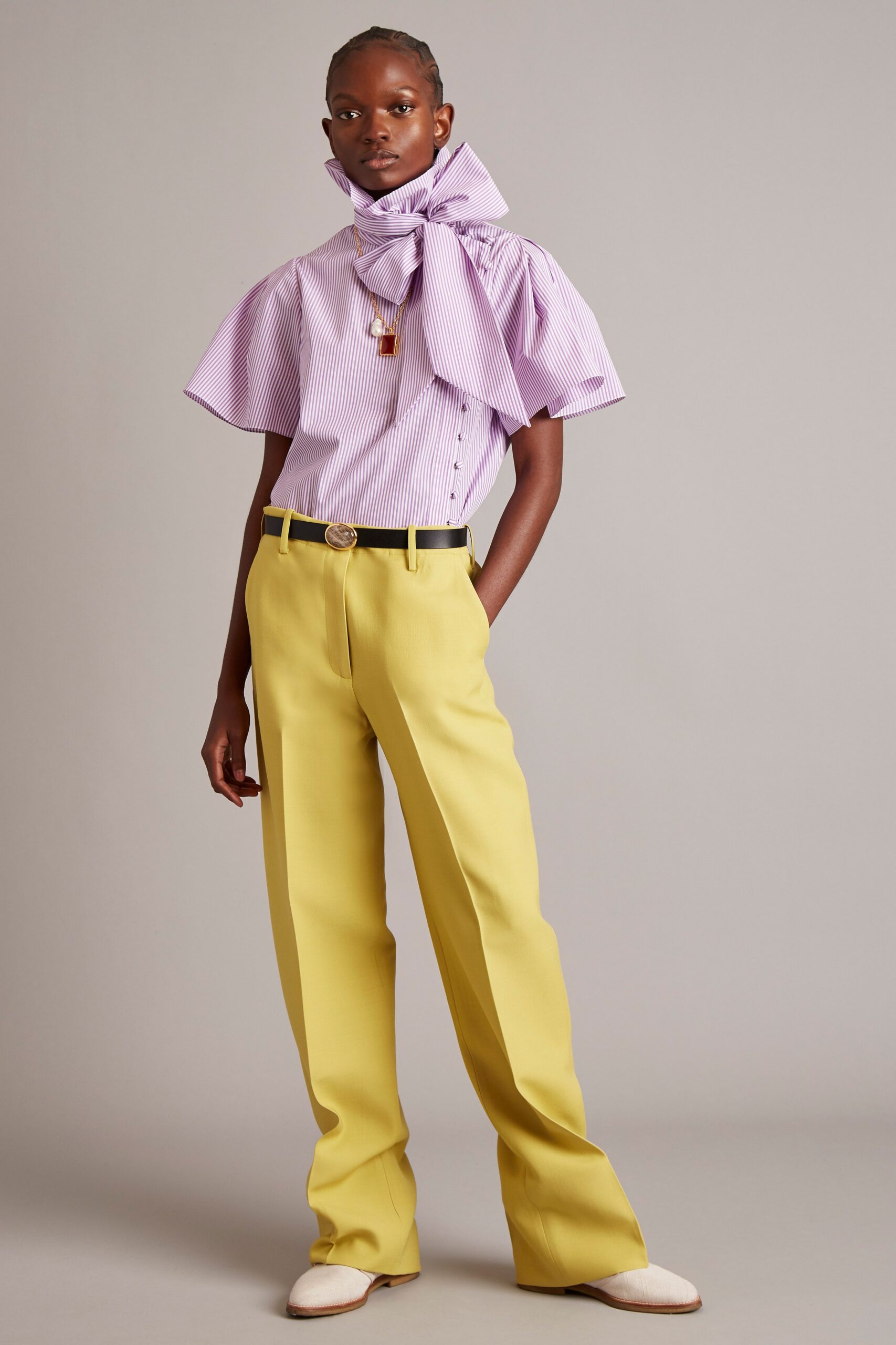 purple and white pleated shirt with yellow tailored pants