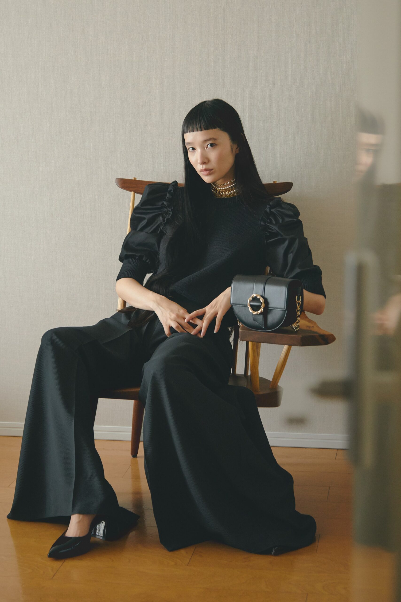 black ruffled top and wide-leg pants