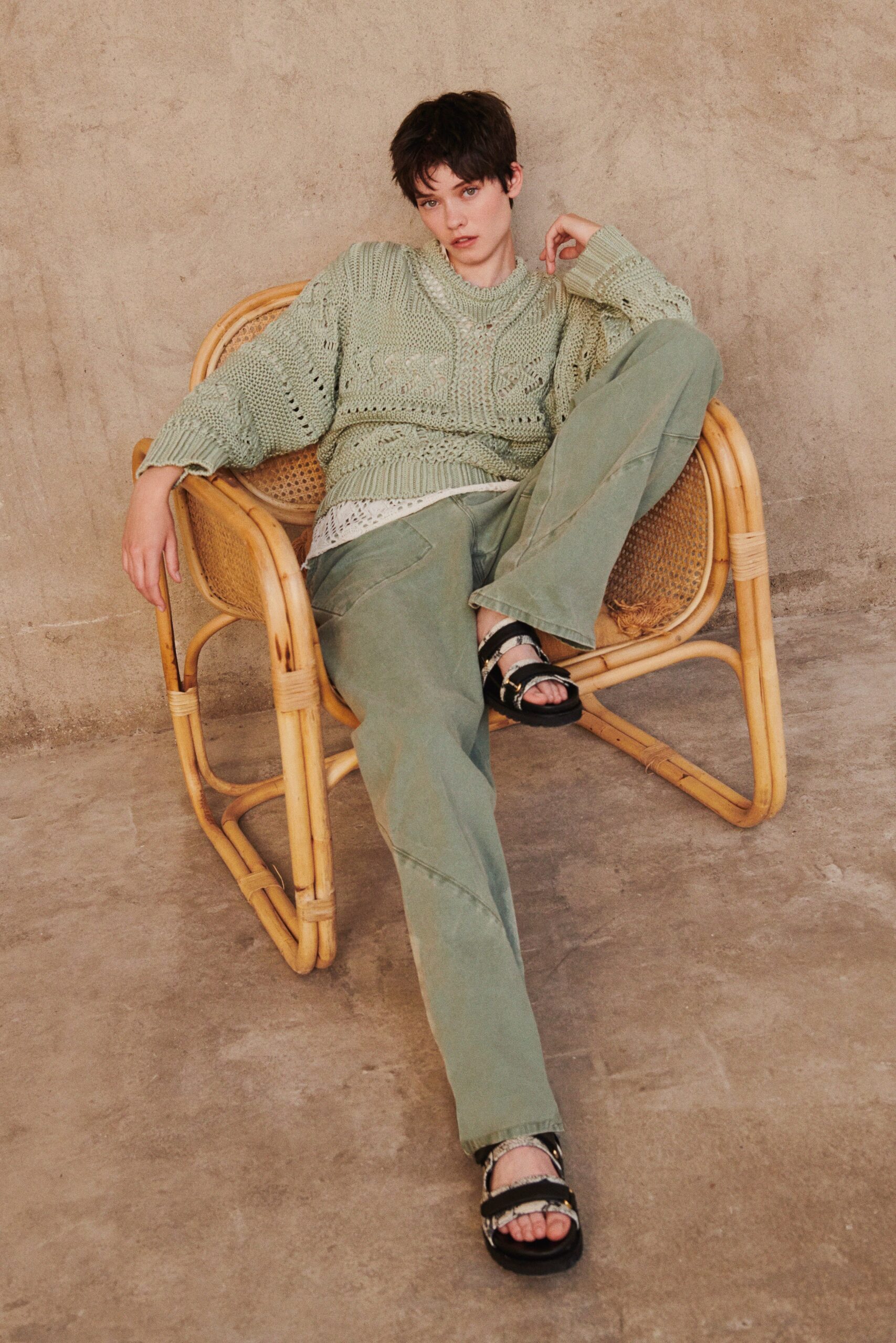 green knit sweater with beige pants