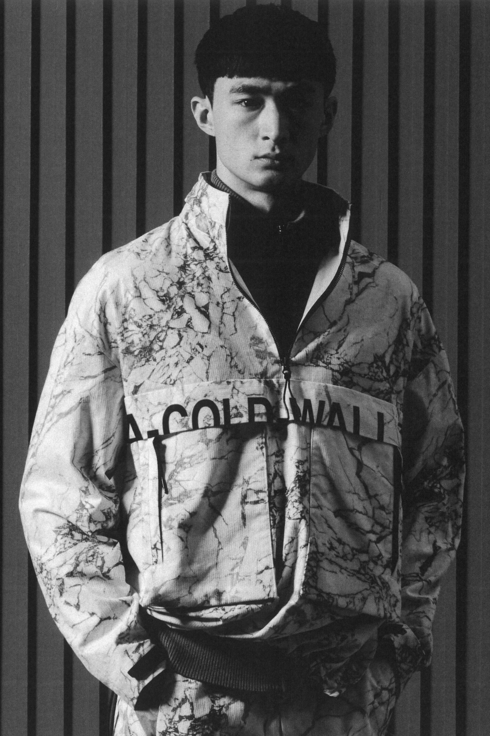 A relaxed black and white printed jacket with long sleeves and a collared design.