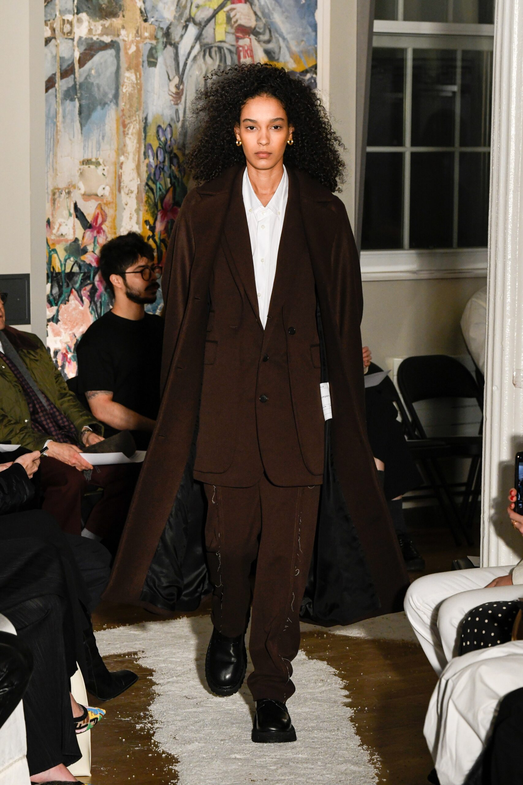 A relaxed brown wool coat suit with long sleeves and a collared design.