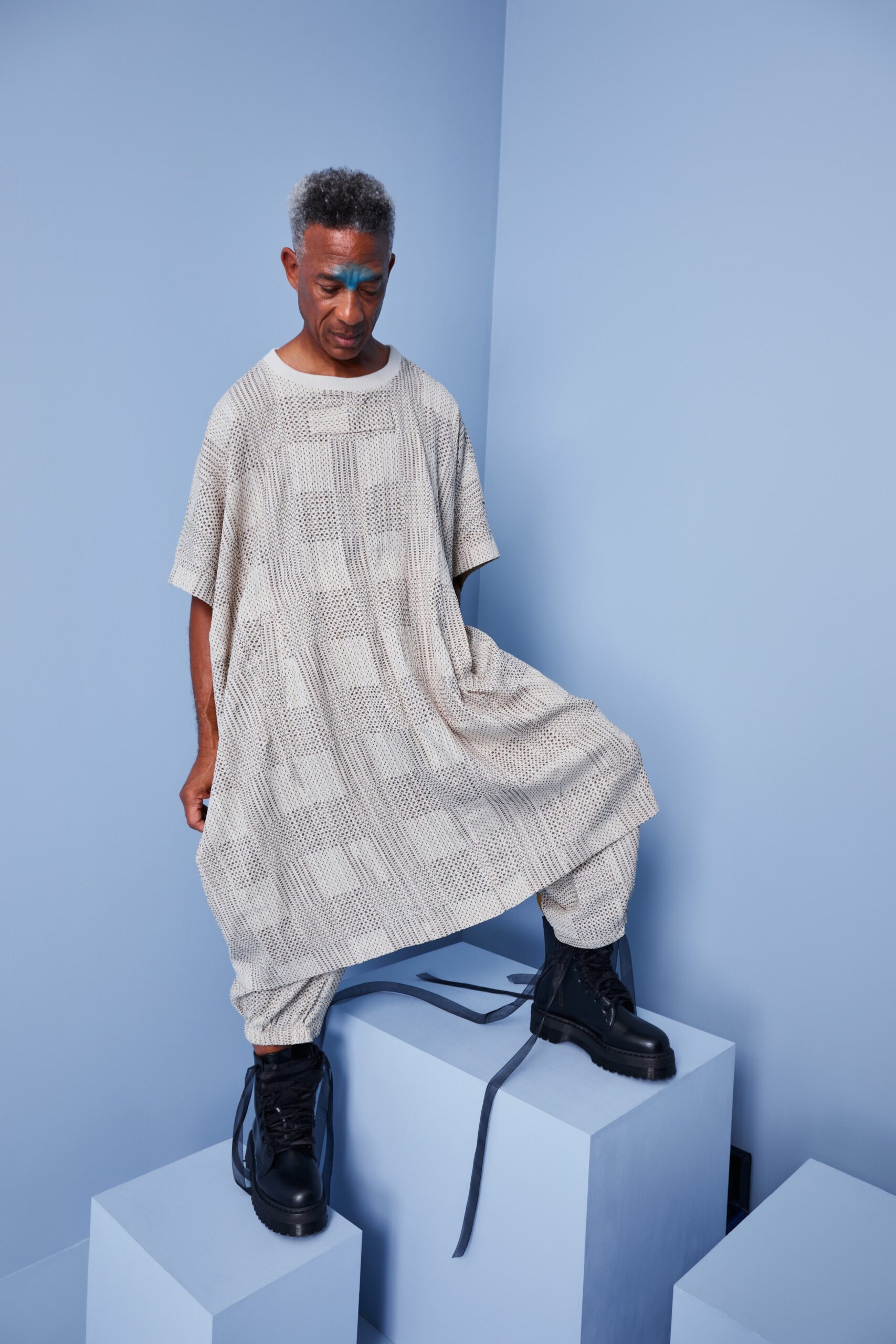 This relaxed dress features a unique asymmetric design, layered for added depth and movement. The short sleeves and collared neckline create a modern silhouette, while the cotton fabric enhances comfort and ease.