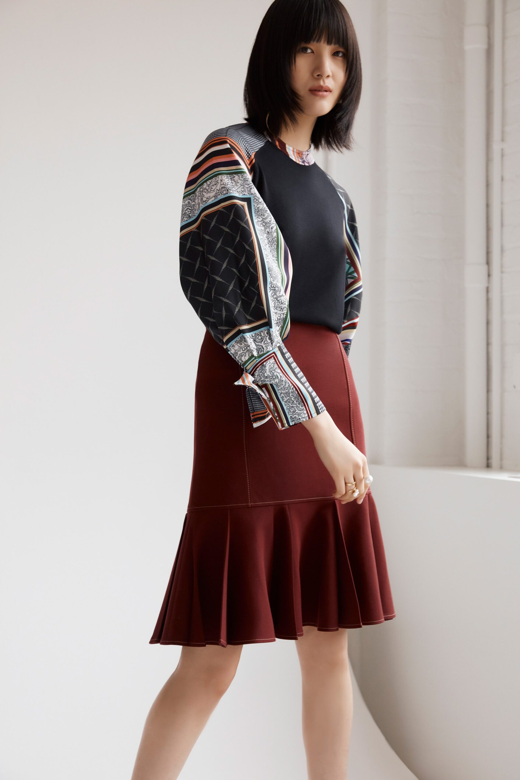 black multi top with red flared skirt