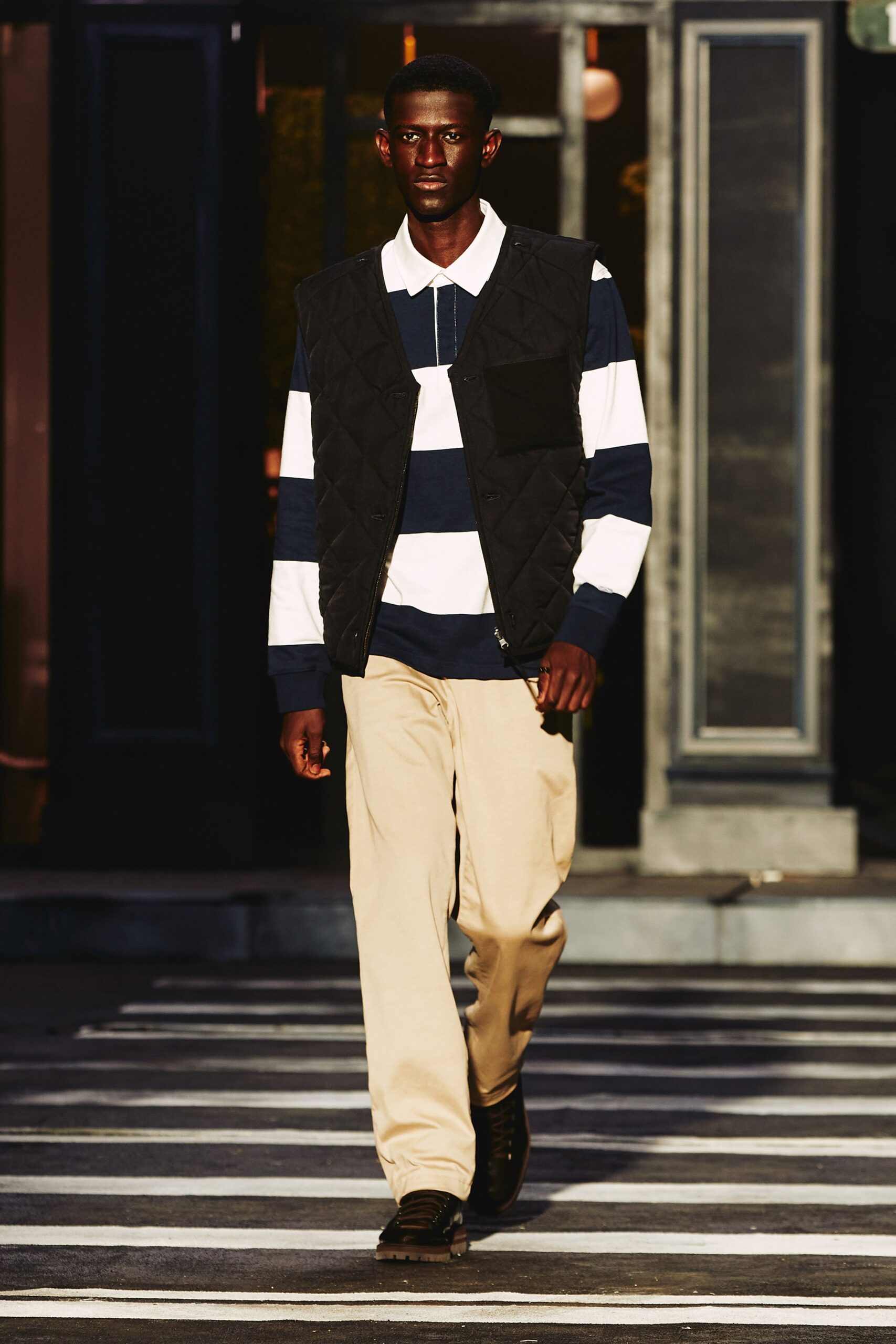 A relaxed long-sleeve black and white striped shirt with a collared neckline.