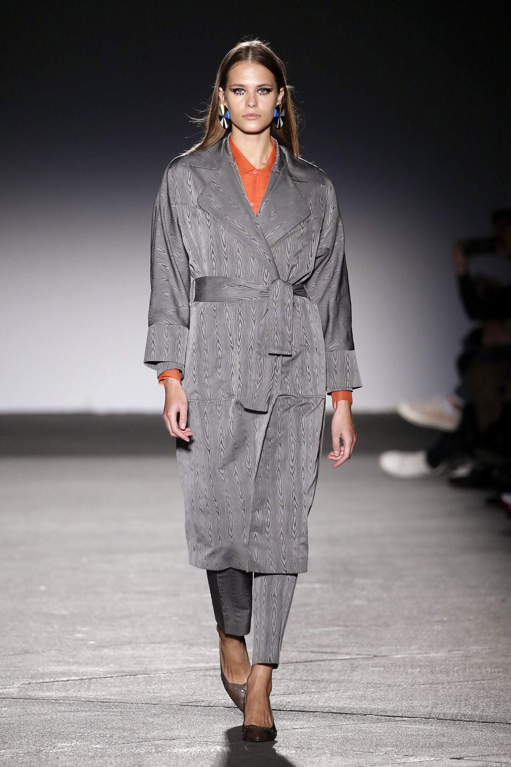 gray silk belted coat with orange shirt
