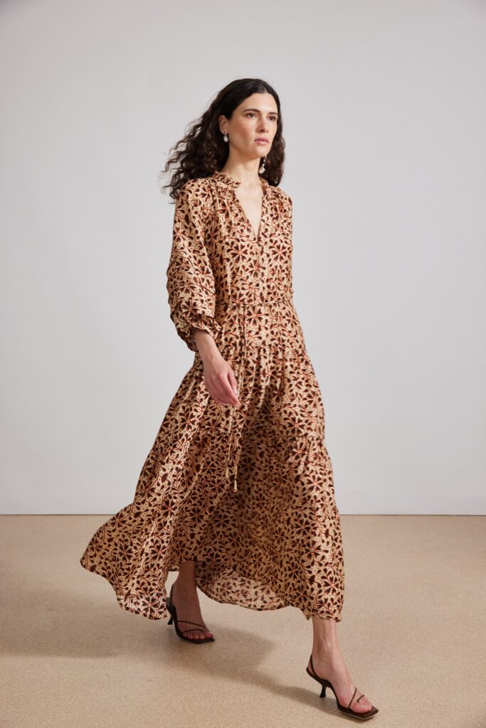 A relaxed brown silk dress with long sleeves and a V-neckline featuring a printed design.