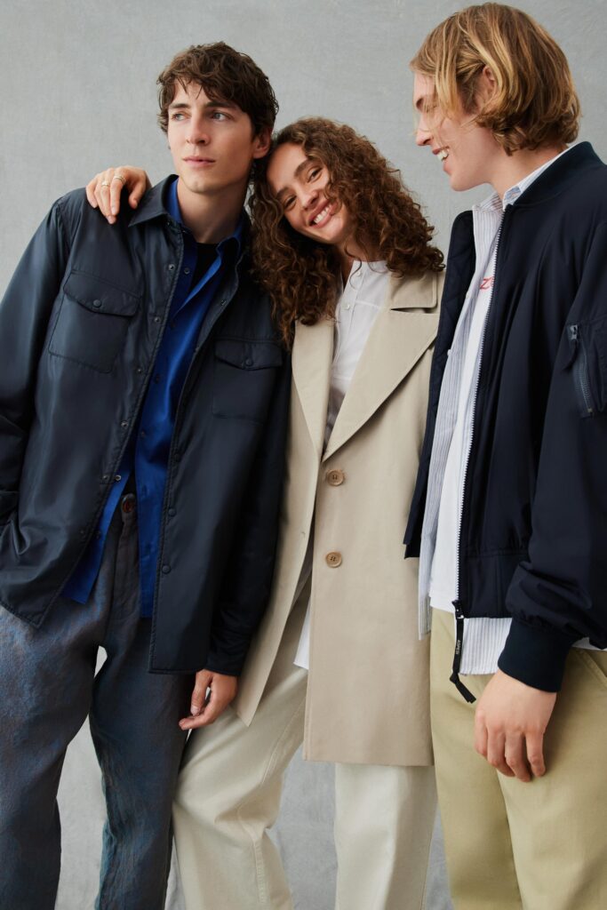 A relaxed beige coat with long sleeves and a collared neckline, featuring button details.
