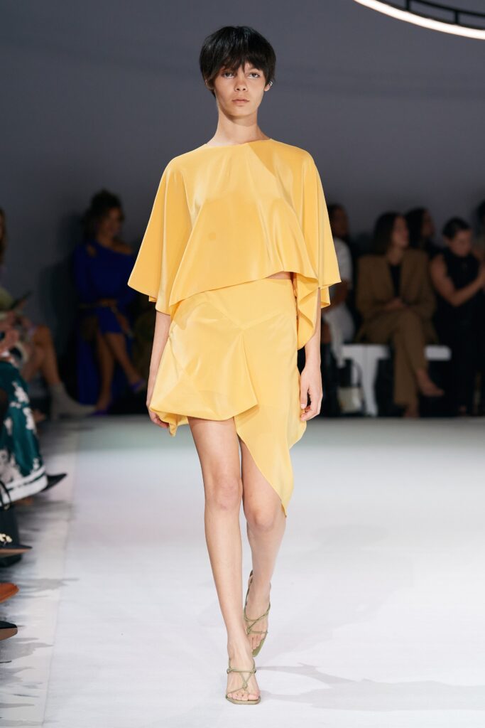 A relaxed yellow silk dress with a sleeveless design and asymmetric silhouette.