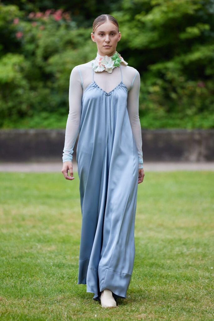 A longline blue silk sleeveless dress with a flowing silhouette and delicate neckline.