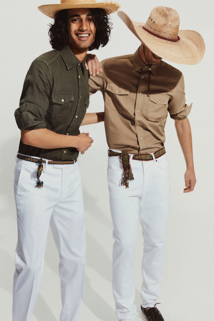 A relaxed beige cotton long-sleeve shirt paired with white pants, featuring buttoned details.