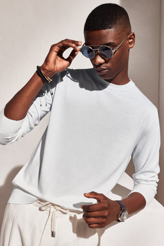 A relaxed white long-sleeve sweater paired with comfortable pants, perfect for casual outings.