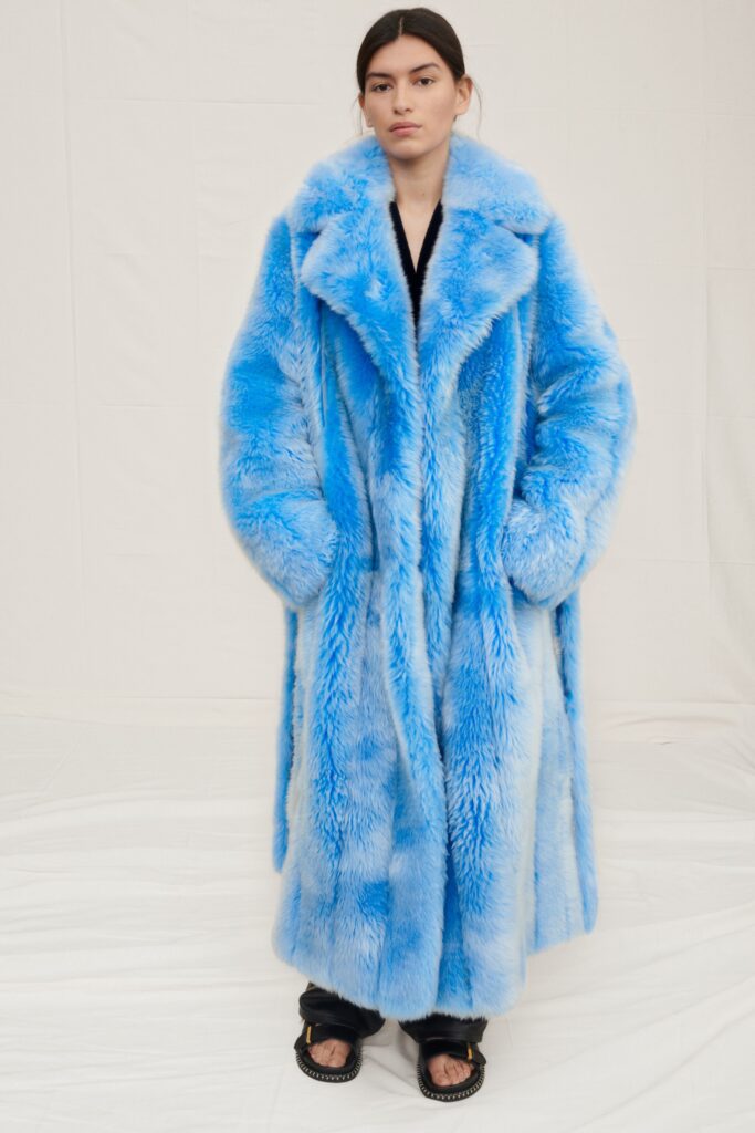 An oversized blue faux-fur coat with long sleeves and a collared design.