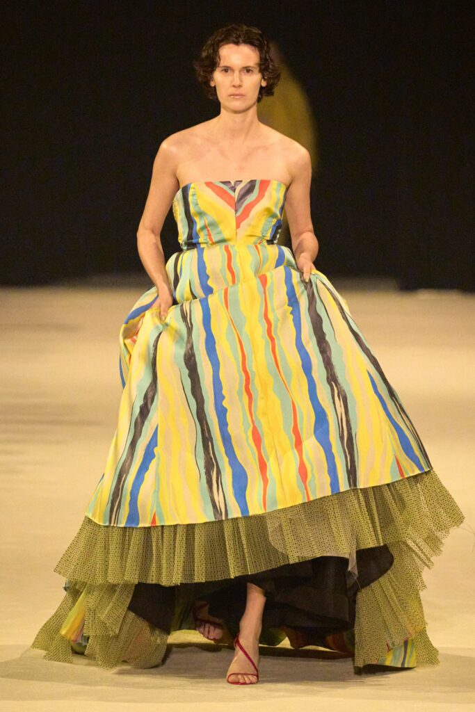 A fitted multicolor tiered strapless dress featuring a vibrant design and layered texture.