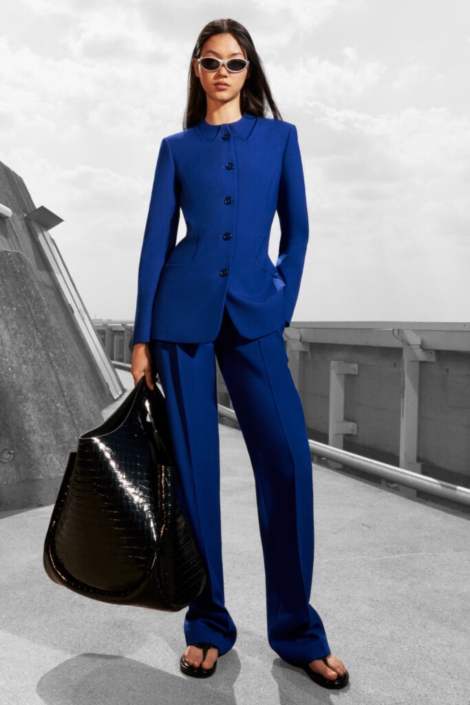 A tailored blue suit with long sleeves and a collared design, featuring straight-leg trousers.