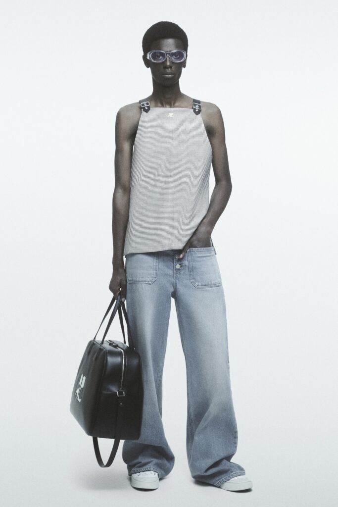 A relaxed gray sleeveless top paired with wide-leg blue denim pants.