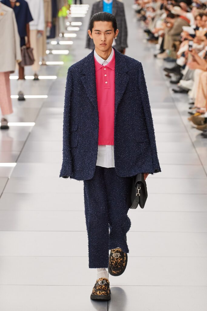 A relaxed navy cotton suit with a collared long-sleeve shirt and buttoned details.